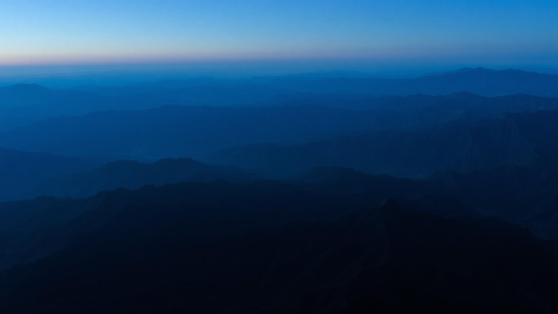Layered mountain ridges at blue hour