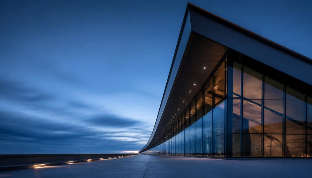 Converging steel and glass structural lines of a modern facility at blue hour